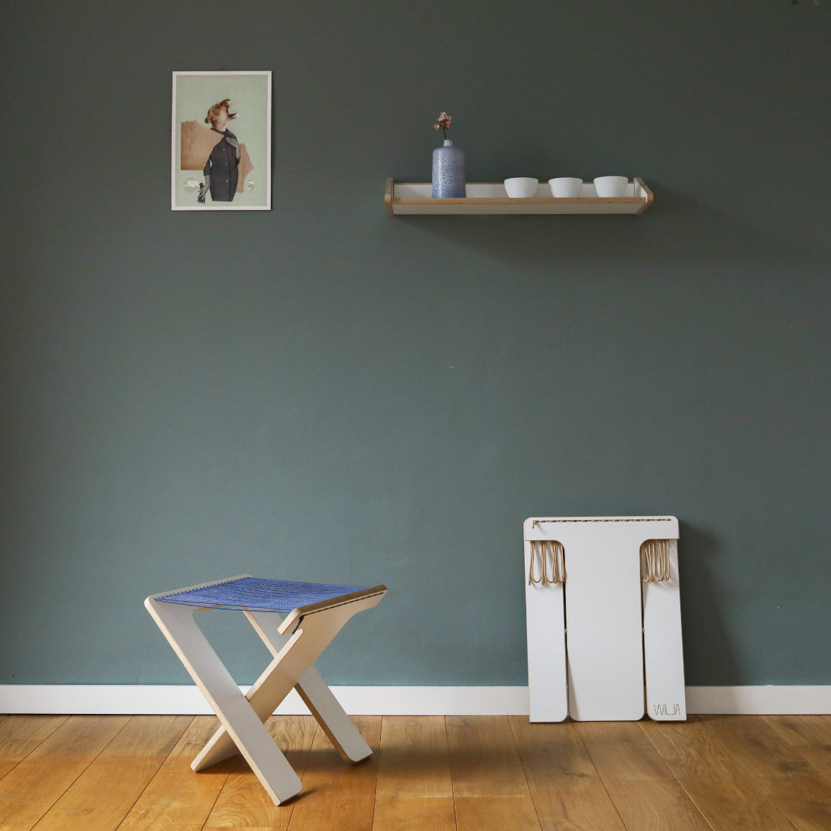WILJA Klapphocker Karl faltbar aus Holz mit Seil in dunkelblau im Zimmer mobiles Sitzmöbel im Licht